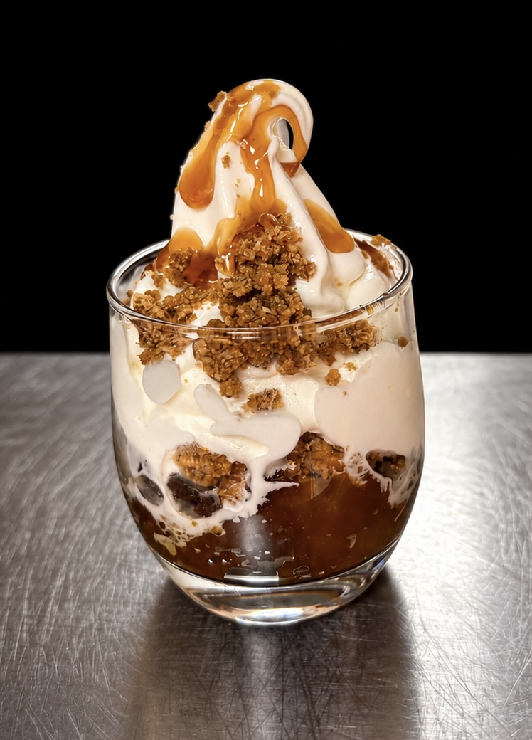 Apple Crumble Sundae layered with warm spiced apples, almond crumble, caramel and soft serve